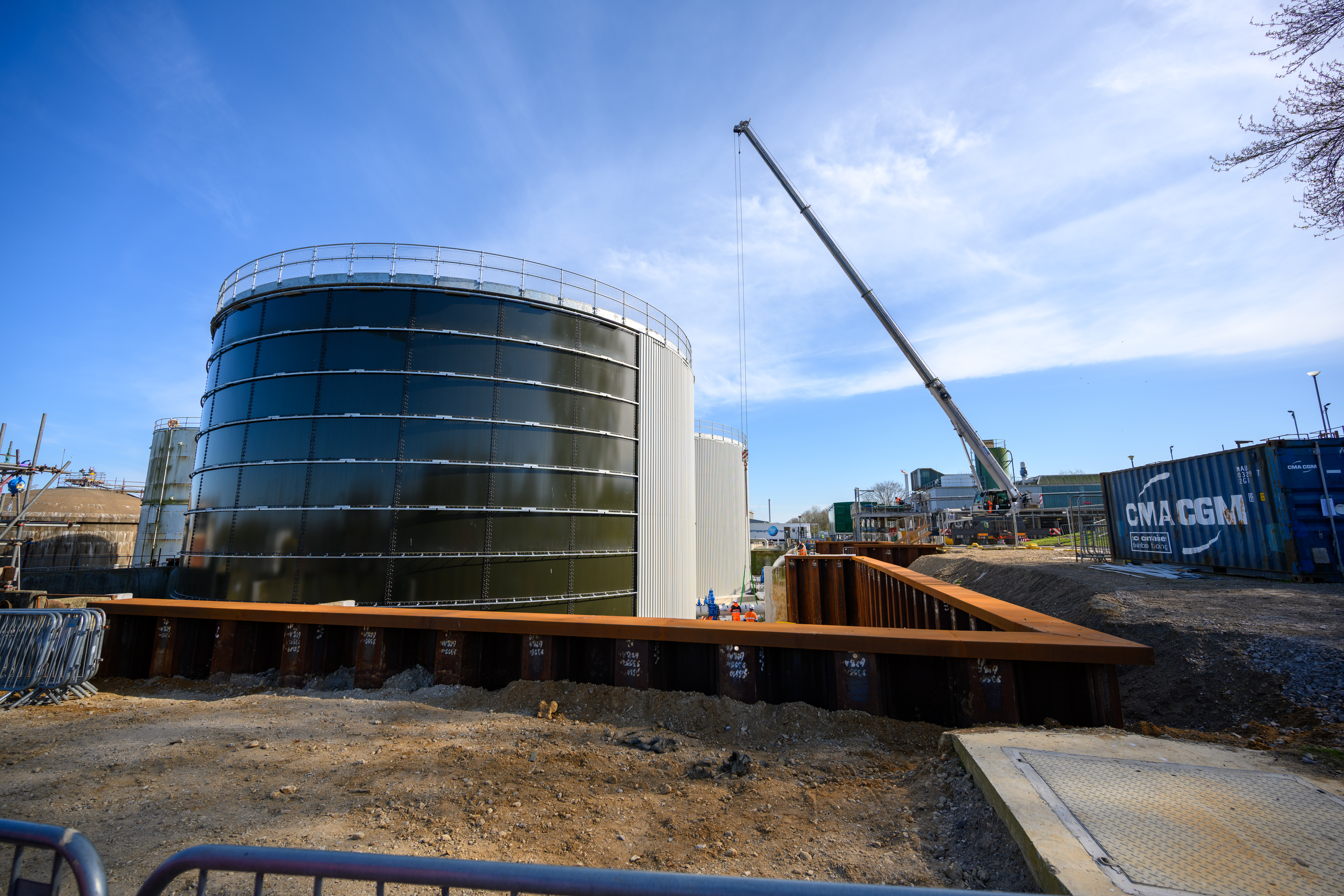 Crane operating beside large storage tank at Whitlingham STC
